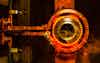 Closeup calcining hot metal steel gear parts in a factory induction furnace with smoke and flame