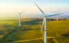 Panoramic view of wind farm or wind park with high wind turbines for generation electricity