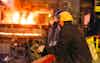 Workers in the steel mill arc furnace